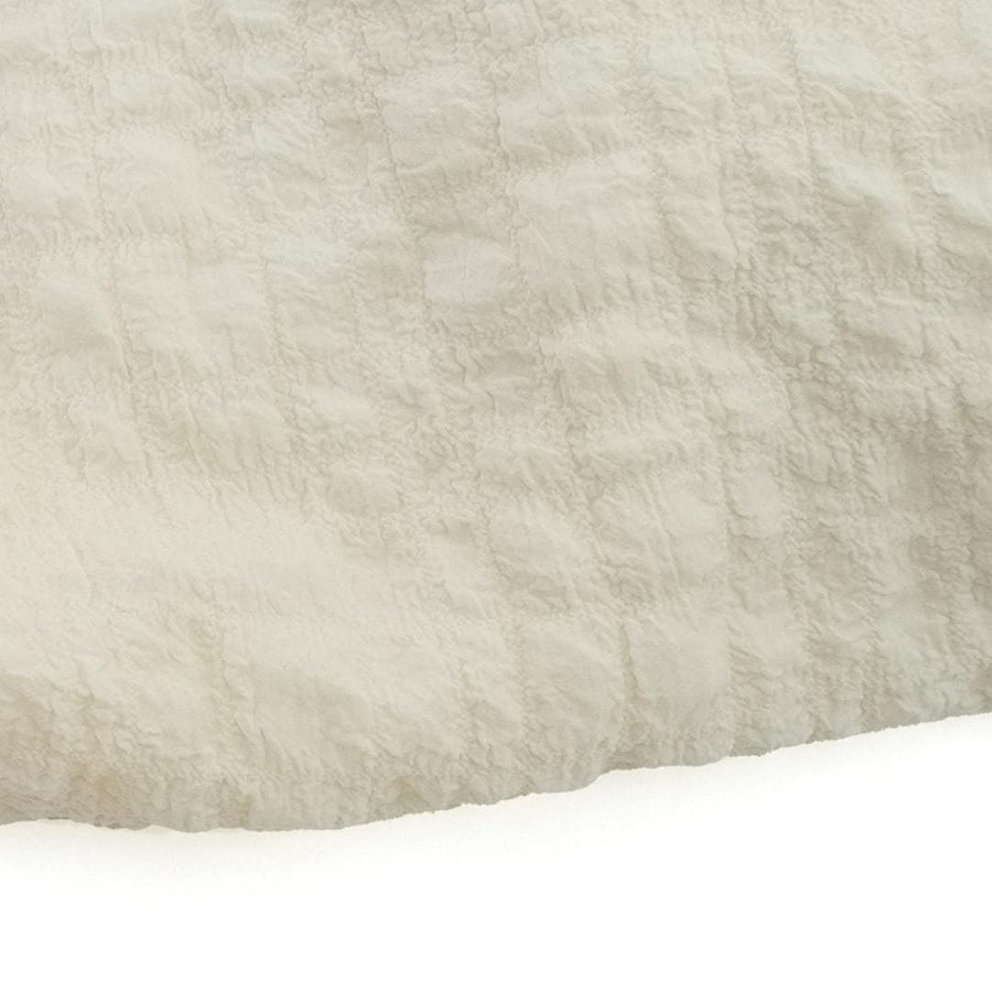 A crumpled drawstring gathered handle bag