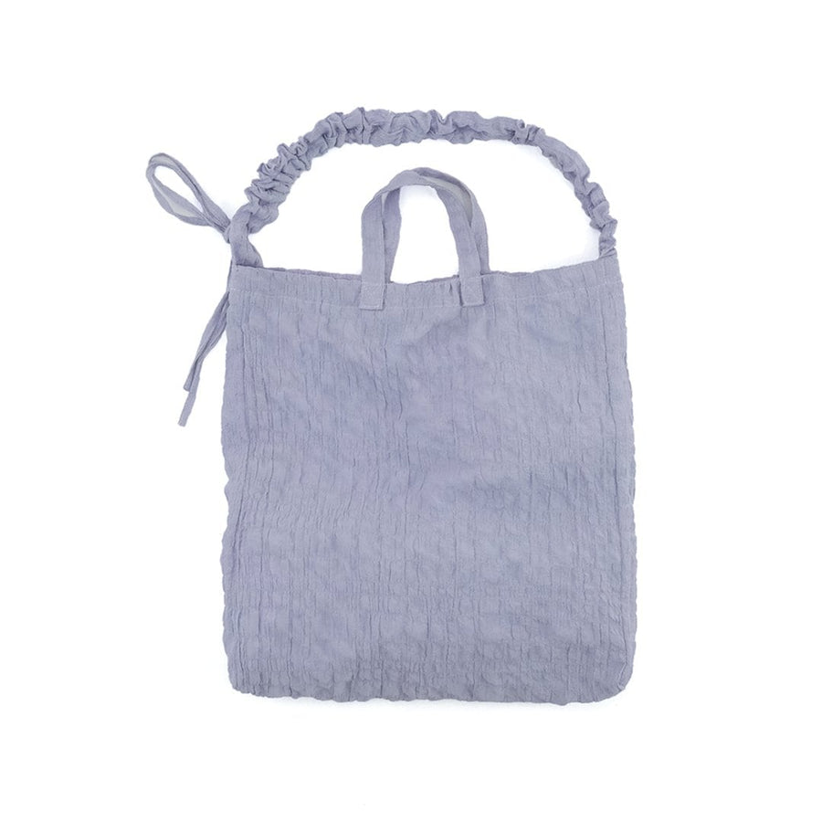 A crumpled drawstring gathered handle bag