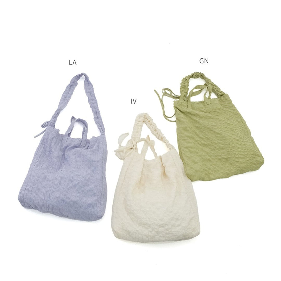 A crumpled drawstring gathered handle bag