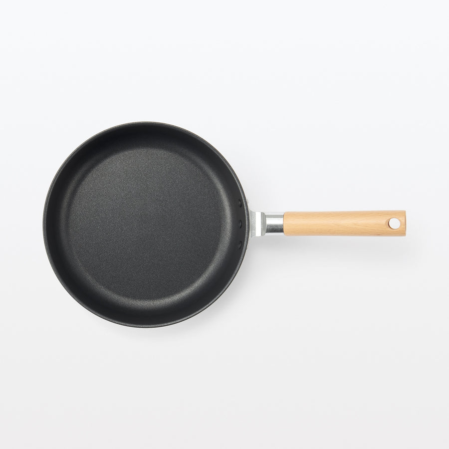 A shallow frying pan with a large cooking surface and low sticking properties