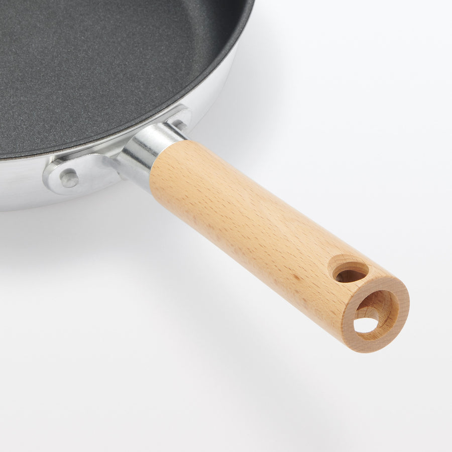 A shallow frying pan with a large cooking surface and low sticking properties
