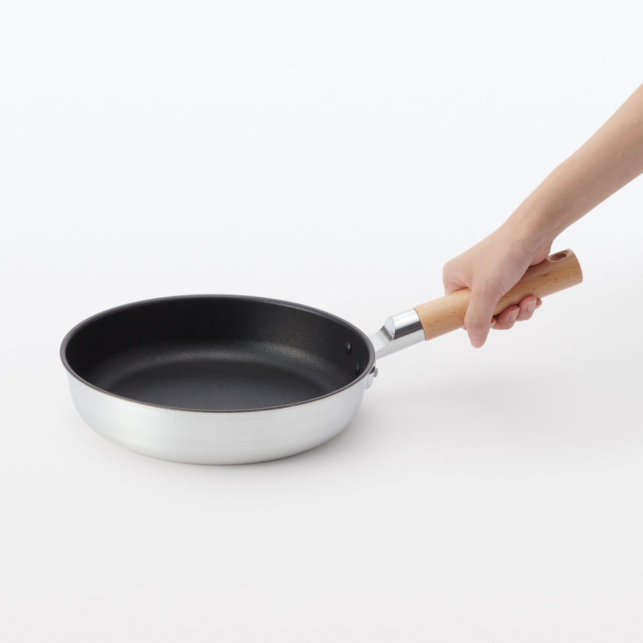 A shallow frying pan with a large cooking surface and low sticking properties