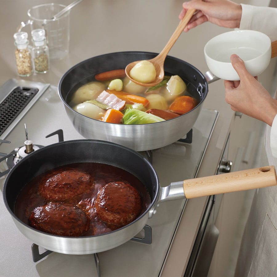 A shallow frying pan with a large cooking surface and low sticking properties