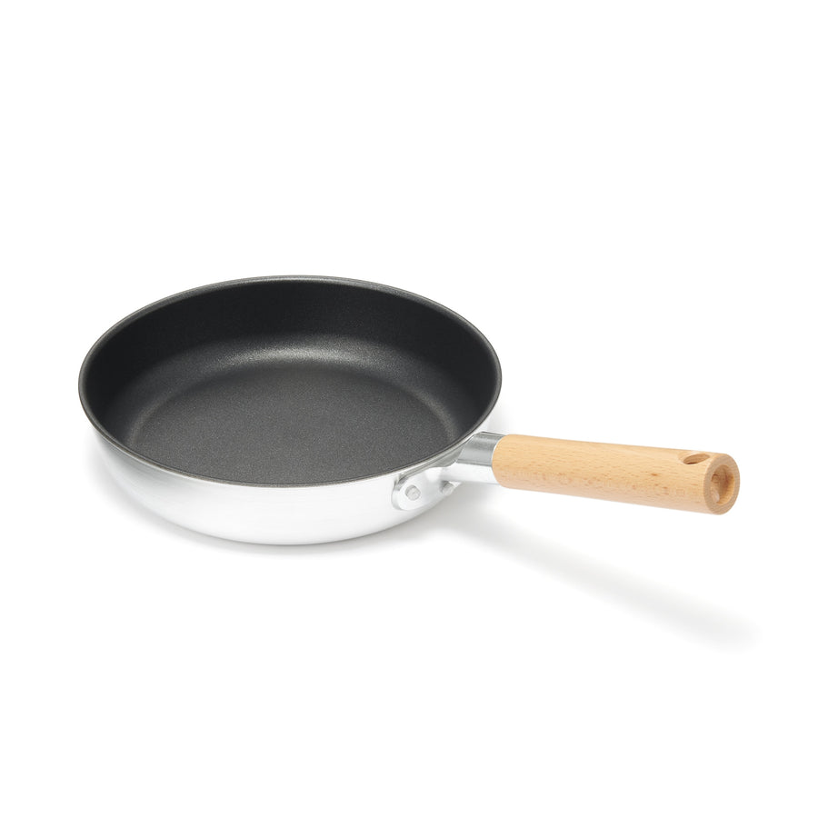 A shallow frying pan with a large cooking surface and low sticking properties