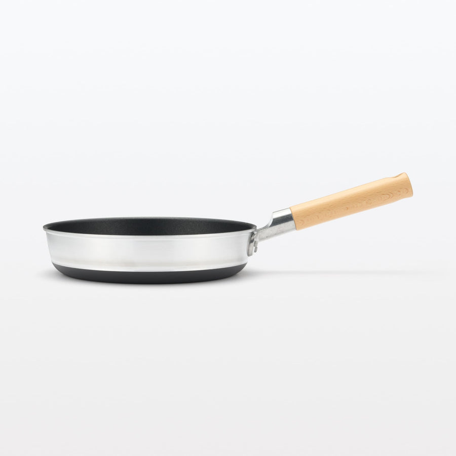 A shallow frying pan with a large cooking surface and low sticking properties