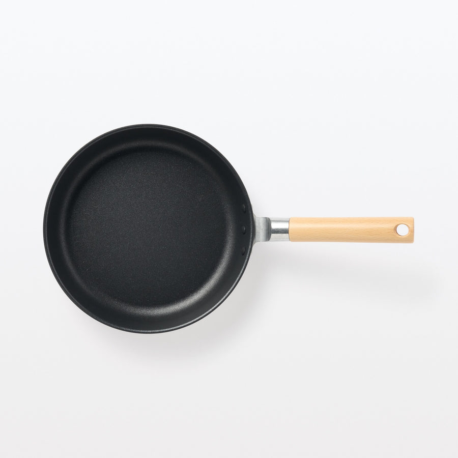 A shallow frying pan with a large cooking surface and low sticking properties