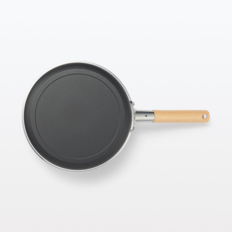 A shallow frying pan with a large cooking surface and low sticking properties