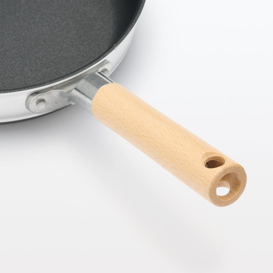 A shallow frying pan with a large cooking surface and low sticking properties