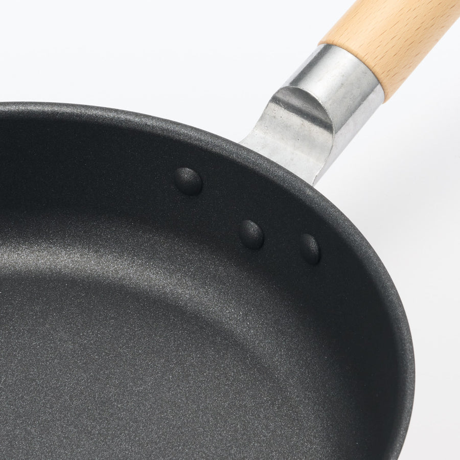 A shallow frying pan with a large cooking surface and low sticking properties