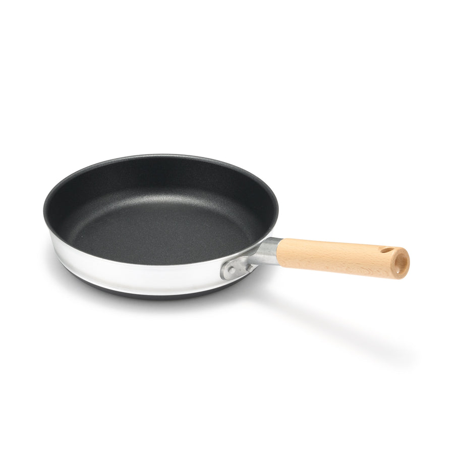 A shallow frying pan with a large cooking surface and low sticking properties