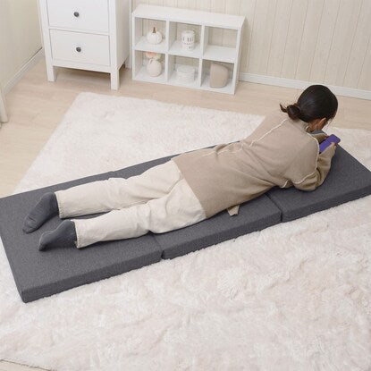 A sleeping mattress that can be used as an ottoman or stool (gray)