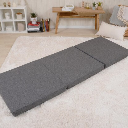 A sleeping mattress that can be used as an ottoman or stool (gray)