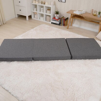 A sleeping mattress that can be used as an ottoman or stool (gray)