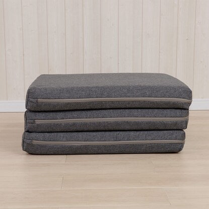 A sleeping mattress that can be used as an ottoman or stool (gray)