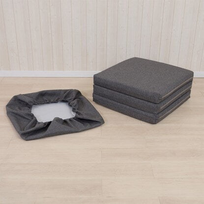 A sleeping mattress that can be used as an ottoman or stool (gray)