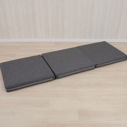 A sleeping mattress that can be used as an ottoman or stool (gray)