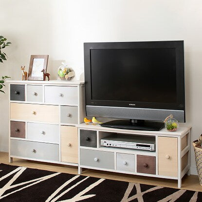 A pale, colorful, shabby TV stand (W84)