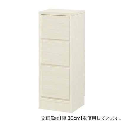 A slim cabinet with a beautiful wood grain pattern and drawers (width 30 x height 85 cm, gloss finish WW)