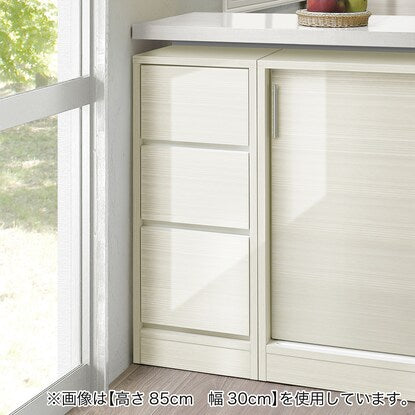 A slim cabinet with a beautiful wood grain pattern and drawers (width 30 x height 85 cm, gloss finish WW)