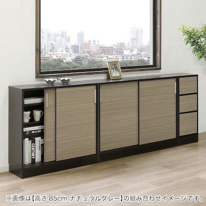 A slim cabinet with a beautiful wood grain pattern and drawers (width 32 x height 85 cm, gloss finish WW)