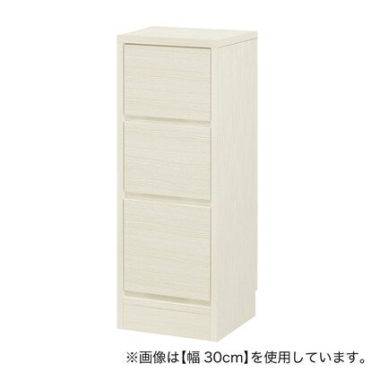 A slim cabinet with a beautiful wood grain pattern and drawers (width 33 x height 85 cm, gloss finish WW)