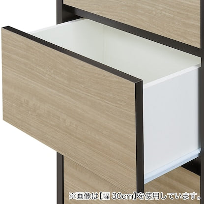 A slim cabinet with a beautiful wood grain pattern and drawers (width 31 x height 85 cm NGY)