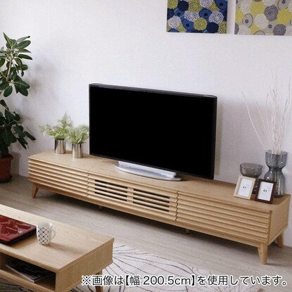 A TV stand (175 NA) with attractive natural wood decorations