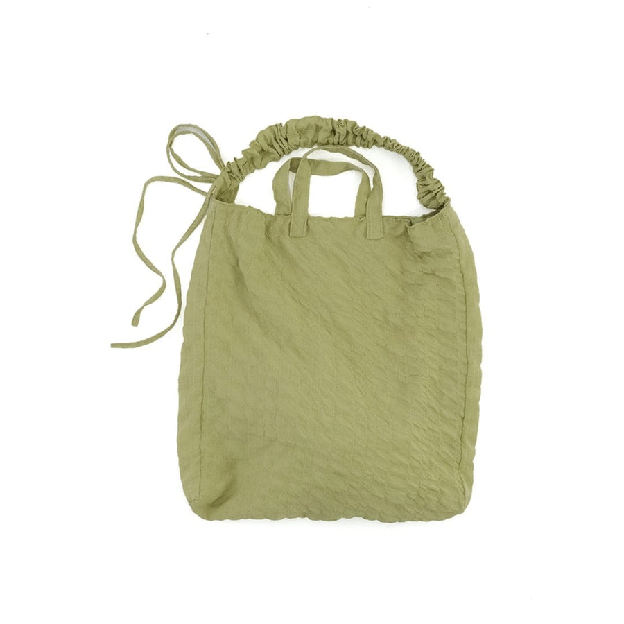 A crumpled drawstring gathered handle bag