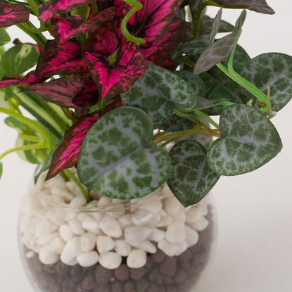 Fake greenery in a glass pot (2 glass pots in a green pot)