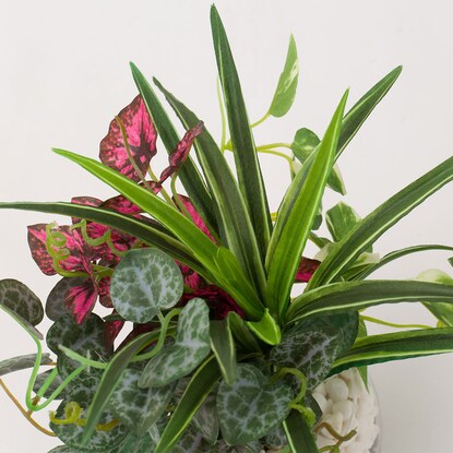 Fake greenery in a glass pot (2 glass pots in a green pot)