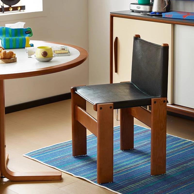 Boxwood and black leather chair