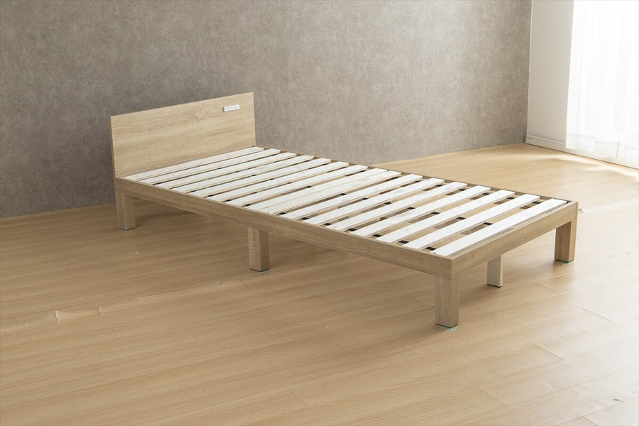 Single bed with outlet and slatted base