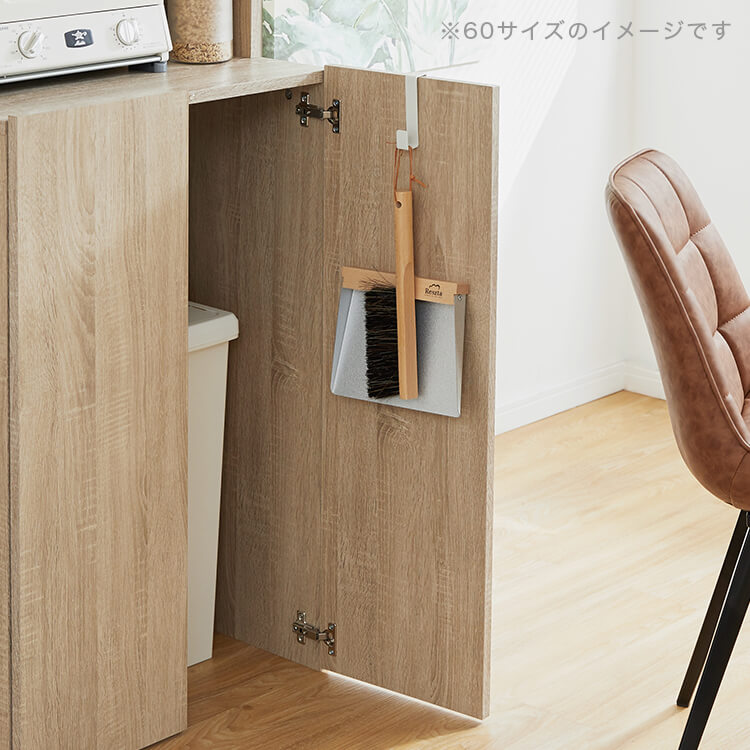 A cupboard perfect for storing things above trash cans