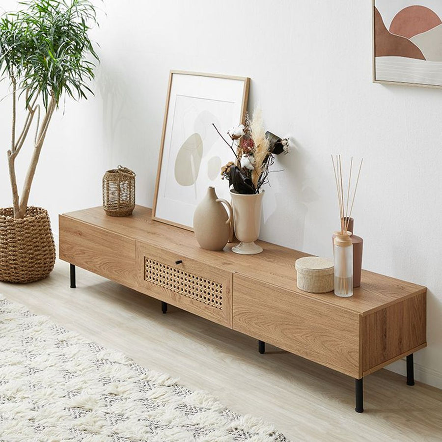 Steel-legged TV stand with rattan finish and cord hole