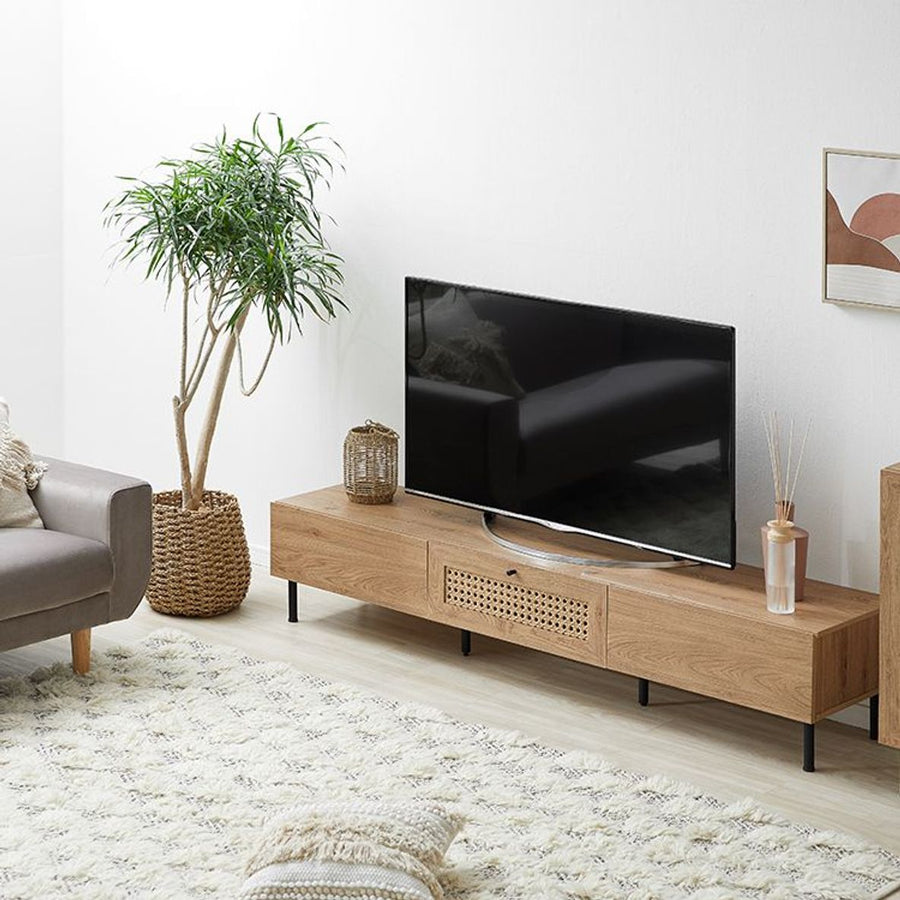 Steel-legged TV stand with rattan finish and cord hole