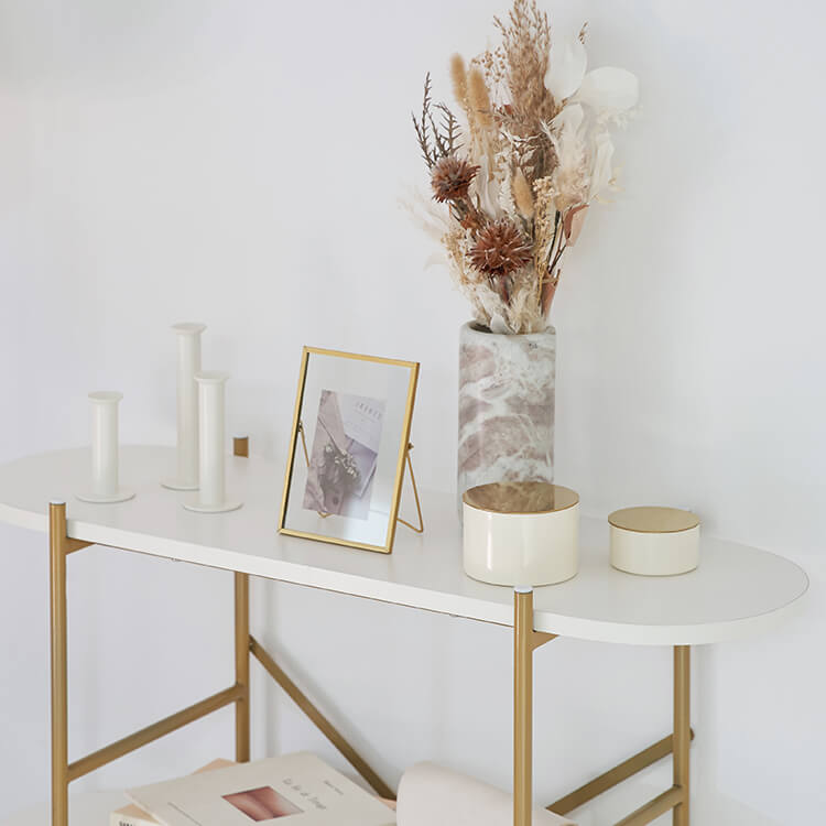 A stylish open shelf in white and gold with 3 tiers