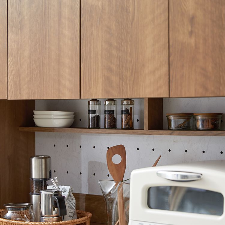 Kitchen cabinet with storage for cooking utensils