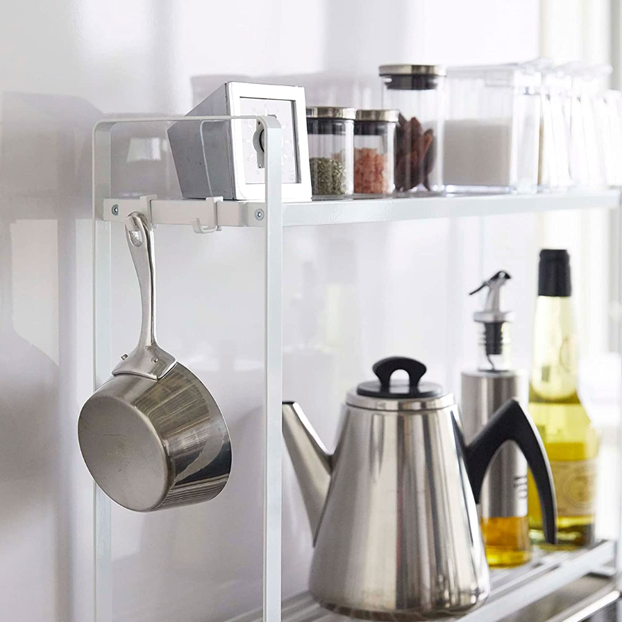 2-tier spice rack next to stove with hooks