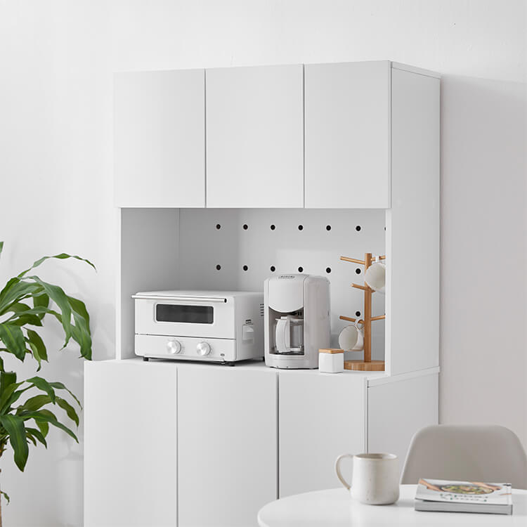 A cupboard perfect for storing things above trash cans