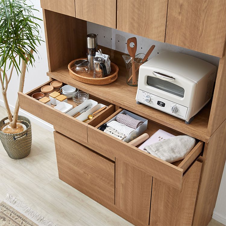Kitchen cabinet with storage for cooking utensils