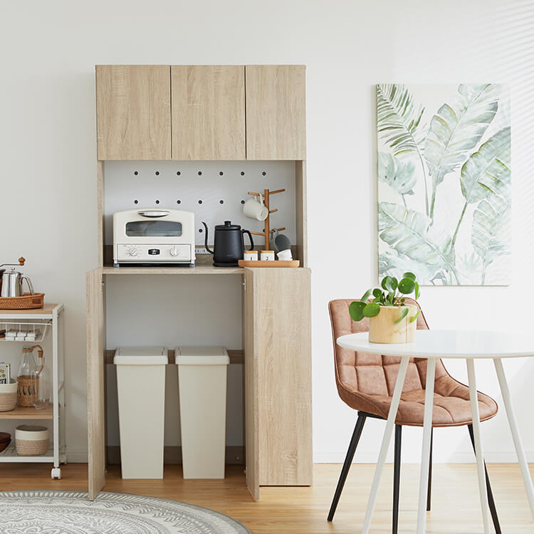 A cupboard perfect for storing things above trash cans
