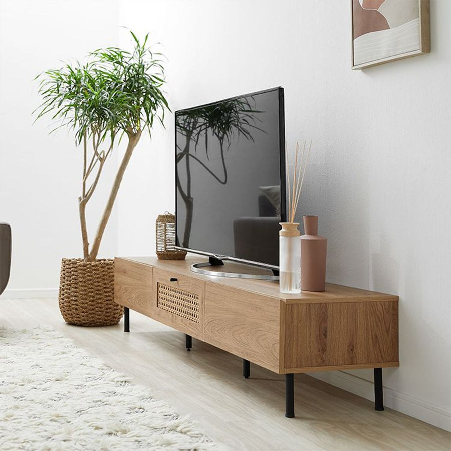 Steel-legged TV stand with rattan finish and cord hole