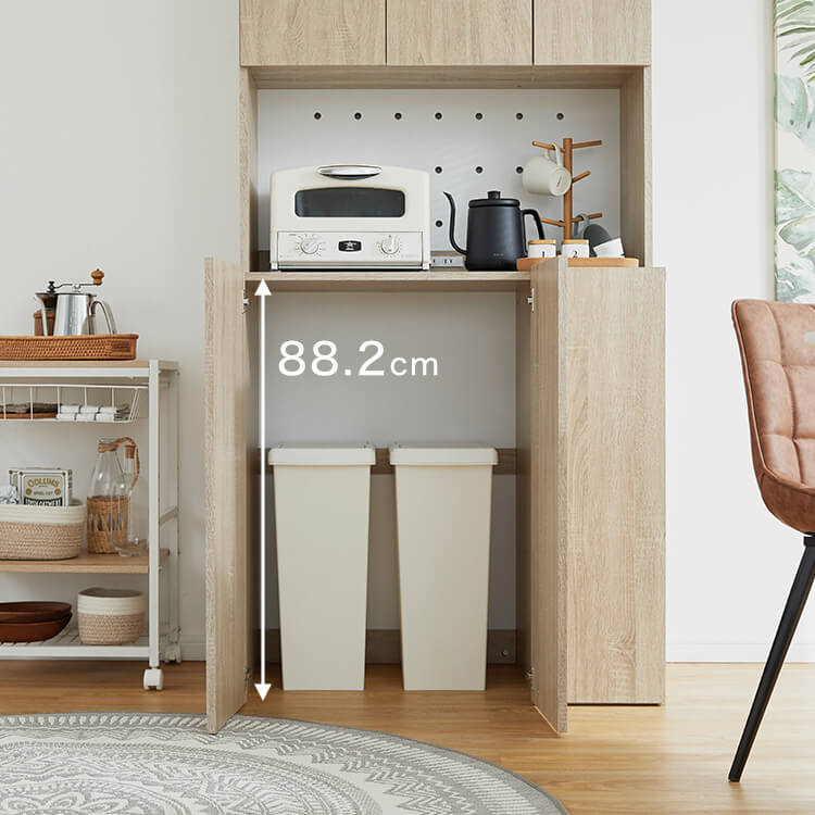 A cupboard perfect for storing things above trash cans