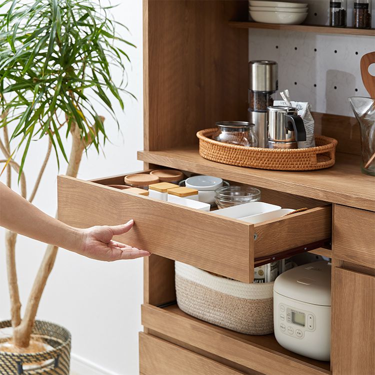 Kitchen cabinet with storage for cooking utensils