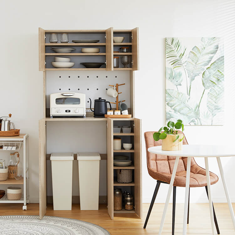 A cupboard perfect for storing things above trash cans