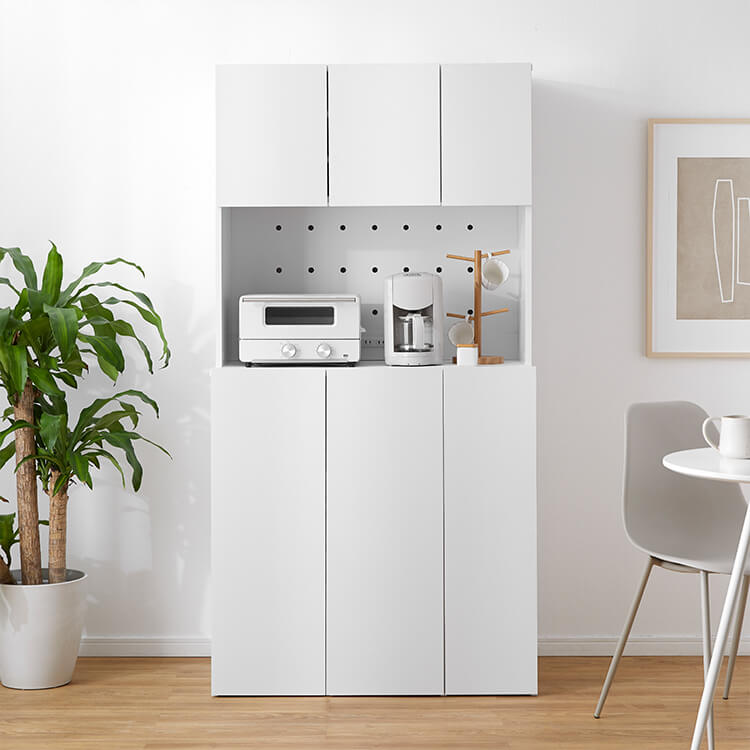 A cupboard perfect for storing things above trash cans