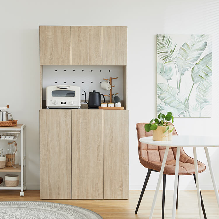 A cupboard perfect for storing things above trash cans