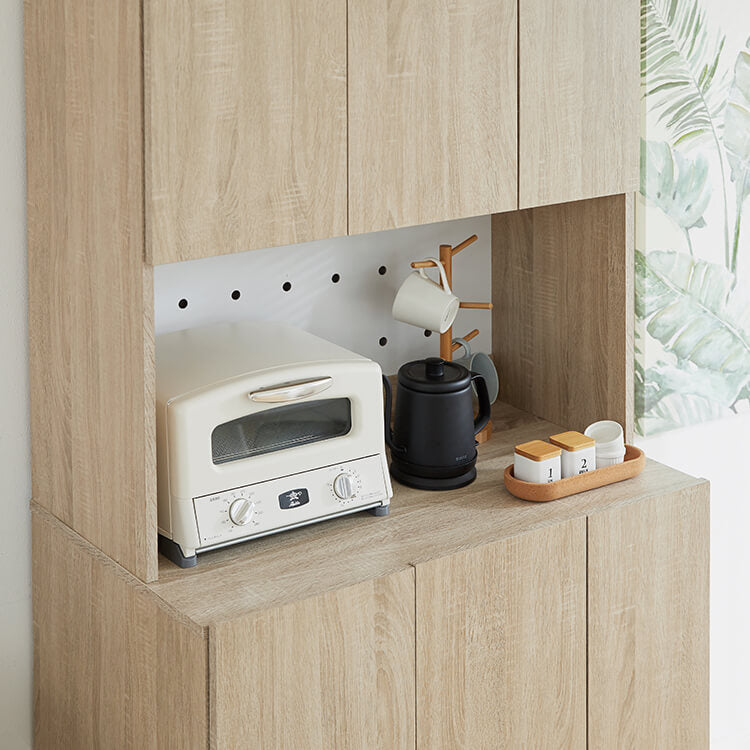 A cupboard perfect for storing things above trash cans