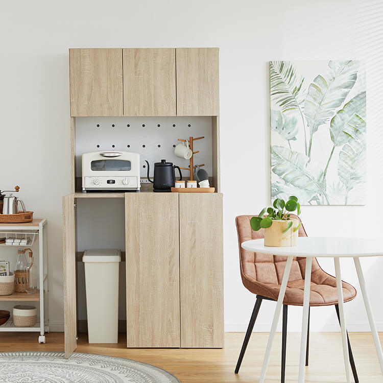 A cupboard perfect for storing things above trash cans