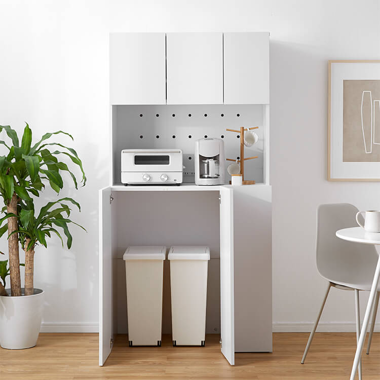 A cupboard perfect for storing things above trash cans